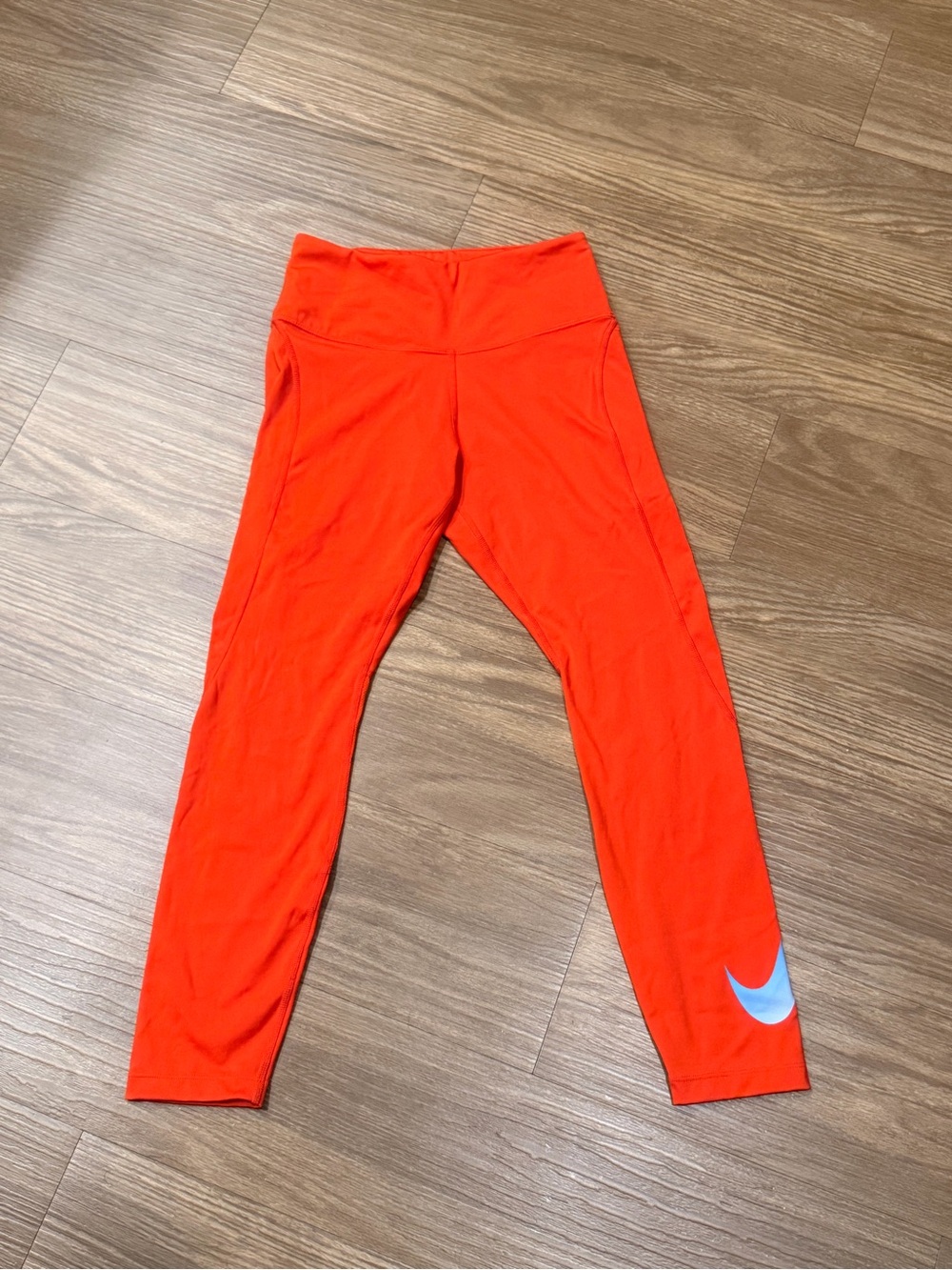 Nike Women's Bright Orange Leggings with Silver Swoosh